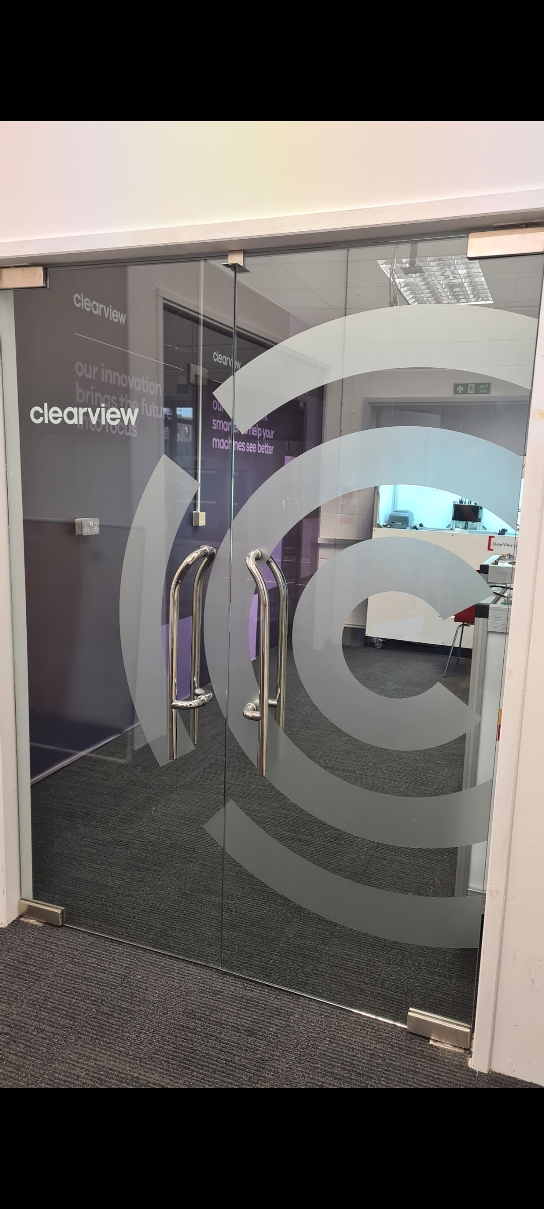 Custom vinyl window graphics on commercial shop windows for branding and promotions