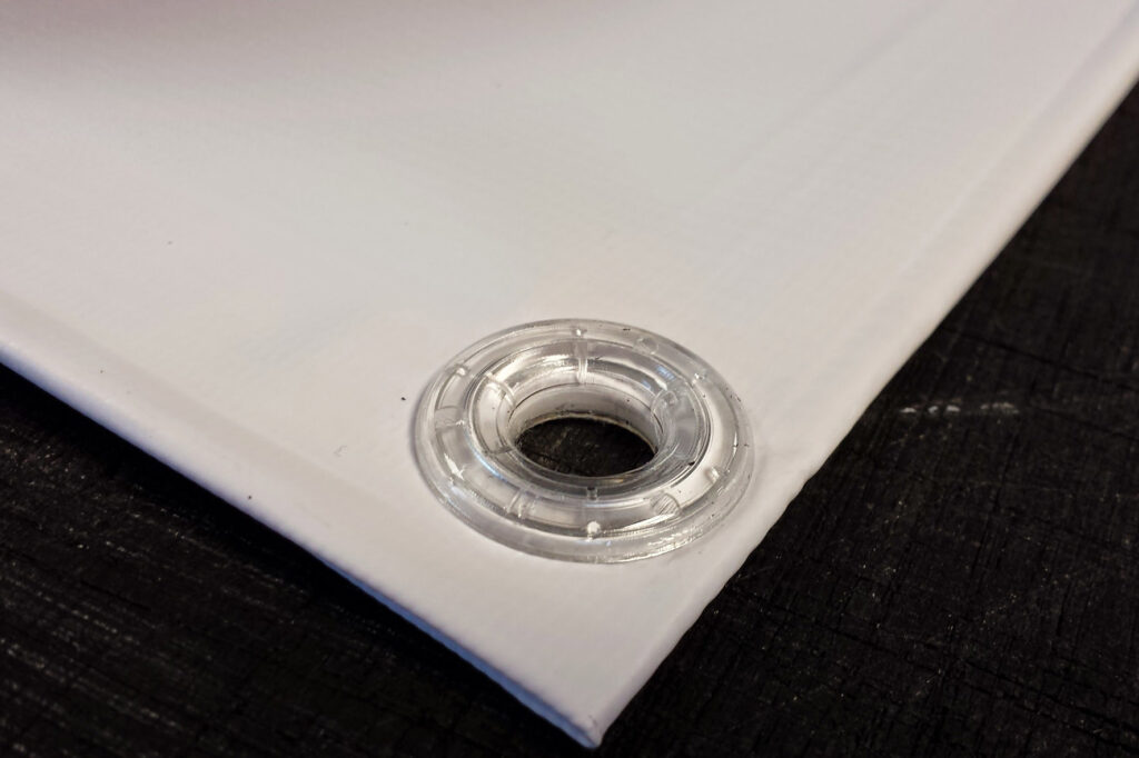 Reinforced eyelets on PVC banner for secure outdoor installation